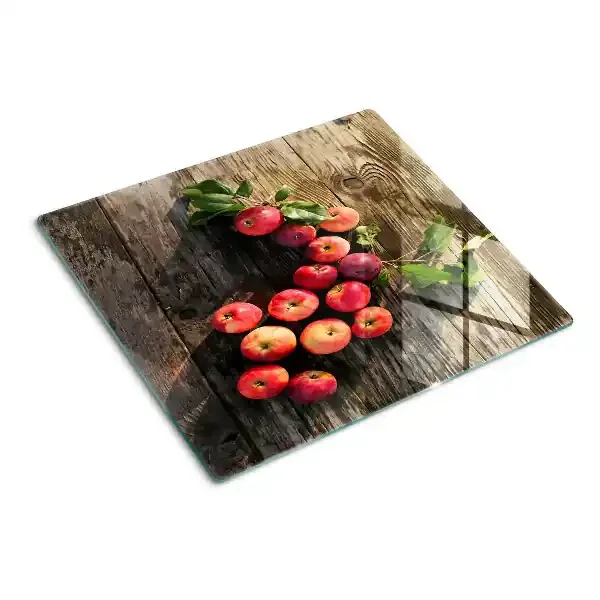 Tabla de cortar de cristal Manzanas sobre un fondo de madera