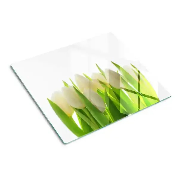 Tabla de cortar de cristal Tulipanes sobre un fondo de hojas verdes.
